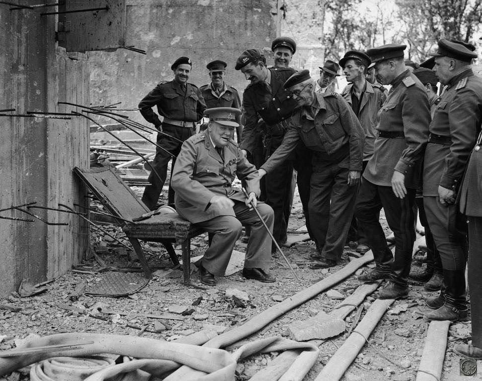 Уинстон Черчилль сидит на том, что осталось от кресла Гитлера в 1945 году